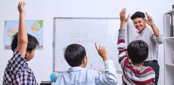 group-of-elementary-school-children-raising-their-2023-11-27-04-50-31-utc